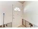 Interior shot of a room with white door with a geometric window and light-colored floors at 216 Archer Way, Anna Maria, FL 34216