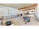 Spacious living room with exposed wood beams and light tile floors, undergoing renovations at 216 Archer Way, Anna Maria, FL 34216