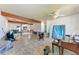 Large open living room with exposed beams and tile flooring in need of some repair at 216 Archer Way, Anna Maria, FL 34216