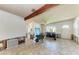 Spacious living room featuring exposed beam ceilings and large windows providing abundant natural light during renovation at 216 Archer Way, Anna Maria, FL 34216