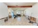 Spacious living room with exposed wood beams and light tile floors, undergoing renovations at 216 Archer Way, Anna Maria, FL 34216
