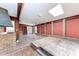 Spacious sunroom featuring a brick fireplace, brick walls, and a skylight for natural light at 216 Archer Way, Anna Maria, FL 34216