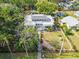Aerial view showcases the manicured lawn, fenced perimeter, and classic architecture of this beautiful property at 2326 2Nd E Ave, Bradenton, FL 34208