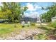 Large backyard with a screened in pool, lush greenery, and views of the charming home at 2326 2Nd E Ave, Bradenton, FL 34208