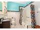 Cozy bathroom features a shower over tub, a floral shower curtain, and black-and-white tiled floors at 2326 2Nd E Ave, Bradenton, FL 34208