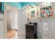 This lovely bathroom features a modern vanity with a dark countertop and unique patterned floor tiles at 2326 2Nd E Ave, Bradenton, FL 34208