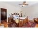 Spacious bedroom featuring a ceiling fan, wood accents, a large bed, and a decorative rug for a cozy feel at 2326 2Nd E Ave, Bradenton, FL 34208