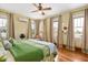 Bright bedroom featuring hardwood floors, neutral walls, ample natural light from surrounding windows and a ceiling fan at 2326 2Nd E Ave, Bradenton, FL 34208