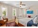 Bright bedroom with white walls, wood floors, ceiling fan, and natural light from large windows at 2326 2Nd E Ave, Bradenton, FL 34208