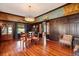 Elegant dining room boasts dark wood paneling, muraled walls, and a decorative chandelier at 2326 2Nd E Ave, Bradenton, FL 34208