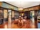Elegant dining room features rich wood paneling, mural art and stunning chandelier lighting at 2326 2Nd E Ave, Bradenton, FL 34208