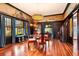 Dining room features hardwood floors, a muraled wall, a chandelier and an adjacent room with ornate doors at 2326 2Nd E Ave, Bradenton, FL 34208