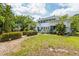 Classic two-story home with beautiful landscaping, mature trees, and a well-maintained lawn at 2326 2Nd E Ave, Bradenton, FL 34208