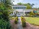 Charming home featuring a manicured front yard, lush shrubbery, and a welcoming entrance at 2326 2Nd E Ave, Bradenton, FL 34208