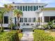 Welcoming porch with decorative lion statues and a variety of potted plants leading to the home's entrance at 2326 2Nd E Ave, Bradenton, FL 34208