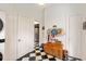 Hallway with checkered tile, wooden cabinet and access to the kitchen at 2326 2Nd E Ave, Bradenton, FL 34208