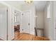 Hallway with a wooden staircase, hardwood floors, and access to the bedroom at 2326 2Nd E Ave, Bradenton, FL 34208