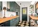 This kitchen features checkerboard floors, wood countertops, green cabinetry, and modern appliances at 2326 2Nd E Ave, Bradenton, FL 34208