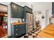 Kitchen displays dark green cabinetry, stainless steel refrigerator, and black and white flooring at 2326 2Nd E Ave, Bradenton, FL 34208