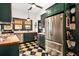 This updated kitchen features checkerboard floors, stainless appliances, and wood counters at 2326 2Nd E Ave, Bradenton, FL 34208