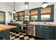 Charming kitchen boasts dark green cabinetry, butcher block counters and stainless steel appliances at 2326 2Nd E Ave, Bradenton, FL 34208