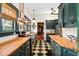 Bright kitchen with checkerboard floors, stainless appliances and wood counters at 2326 2Nd E Ave, Bradenton, FL 34208