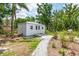 Versatile outbuilding with a white exterior and a charming garden area with a stone pathway at 2326 2Nd E Ave, Bradenton, FL 34208