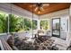 Inviting screened-in porch with comfortable seating, stylish rugs, and views of the lush greenery at 2326 2Nd E Ave, Bradenton, FL 34208
