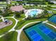 Overhead view of tennis courts, playground, and pool, showing a range of activities at 244 Dove Trl, Bradenton, FL 34212
