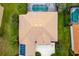 Aerial view of a home with brown roof tiles, solar panels, and a screened-in pool at 244 Dove Trl, Bradenton, FL 34212