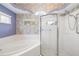Bathroom showcasing a soaking tub and glass-enclosed shower with white tile and elegant fixtures at 244 Dove Trl, Bradenton, FL 34212