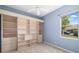 Bedroom featuring custom built-in shelves and a window offering natural light and outdoor views at 244 Dove Trl, Bradenton, FL 34212