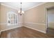 Dining room featuring a modern chandelier and elegant trim work around windows and walls at 244 Dove Trl, Bradenton, FL 34212