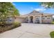 Inviting home featuring a three-car garage, tile roof, and well-maintained landscaping at 244 Dove Trl, Bradenton, FL 34212