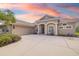 Inviting single-story home featuring a tile roof, manicured landscaping, and a spacious driveway leading to a two-car garage at 244 Dove Trl, Bradenton, FL 34212