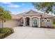 Beautiful single-story home with a tile roof, arched entryway and meticulously maintained landscaping at 244 Dove Trl, Bradenton, FL 34212