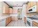 Functional kitchen featuring tile flooring, stainless steel dishwasher, and clean white countertops at 244 Dove Trl, Bradenton, FL 34212
