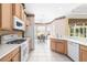 Well-lit kitchen with stainless steel appliances and an adjacent breakfast nook with a view of the pool at 244 Dove Trl, Bradenton, FL 34212