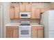 Kitchen with modern appliances, sleek white countertops, and warm wood cabinetry at 244 Dove Trl, Bradenton, FL 34212