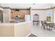 Inviting kitchen with a breakfast bar, stainless steel appliances, and a dining area with a pool view at 244 Dove Trl, Bradenton, FL 34212