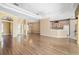Open-concept living room with hardwood floors connecting to the kitchen and dining areas, perfect for entertaining at 244 Dove Trl, Bradenton, FL 34212