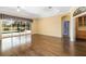 Bright living room with hardwood floors, large windows overlooking a pool, and modern finishes at 244 Dove Trl, Bradenton, FL 34212