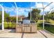 Built-in outdoor kitchen featuring stainless steel appliances with grill, sink, and storage at 244 Dove Trl, Bradenton, FL 34212