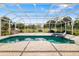 Screened-in pool featuring an attached spa, brick pavers, and outdoor kitchen with grill, sink, and storage at 244 Dove Trl, Bradenton, FL 34212