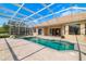 Screened-in pool featuring an attached spa and brick pavers, with multiple access points to the home at 244 Dove Trl, Bradenton, FL 34212