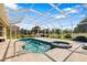 Screened-in pool featuring an attached spa and brick pavers, situated in a backyard with open lawn and perimeter landscaping at 244 Dove Trl, Bradenton, FL 34212