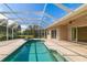 Screened-in pool and spa area featuring brick pavers and a covered area with sliding doors leading into the home at 244 Dove Trl, Bradenton, FL 34212