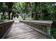 Picturesque wooden walkway offering serene views of lush foliage and community amenities at 244 Dove Trl, Bradenton, FL 34212