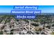 Expansive aerial view of neighborhood near the Manatee River showing the proximity of the water and community at 2705 21St W Ave, Bradenton, FL 34205
