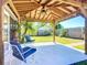 Covered patio featuring tile flooring, seating, and a view of the backyard at 2705 21St W Ave, Bradenton, FL 34205